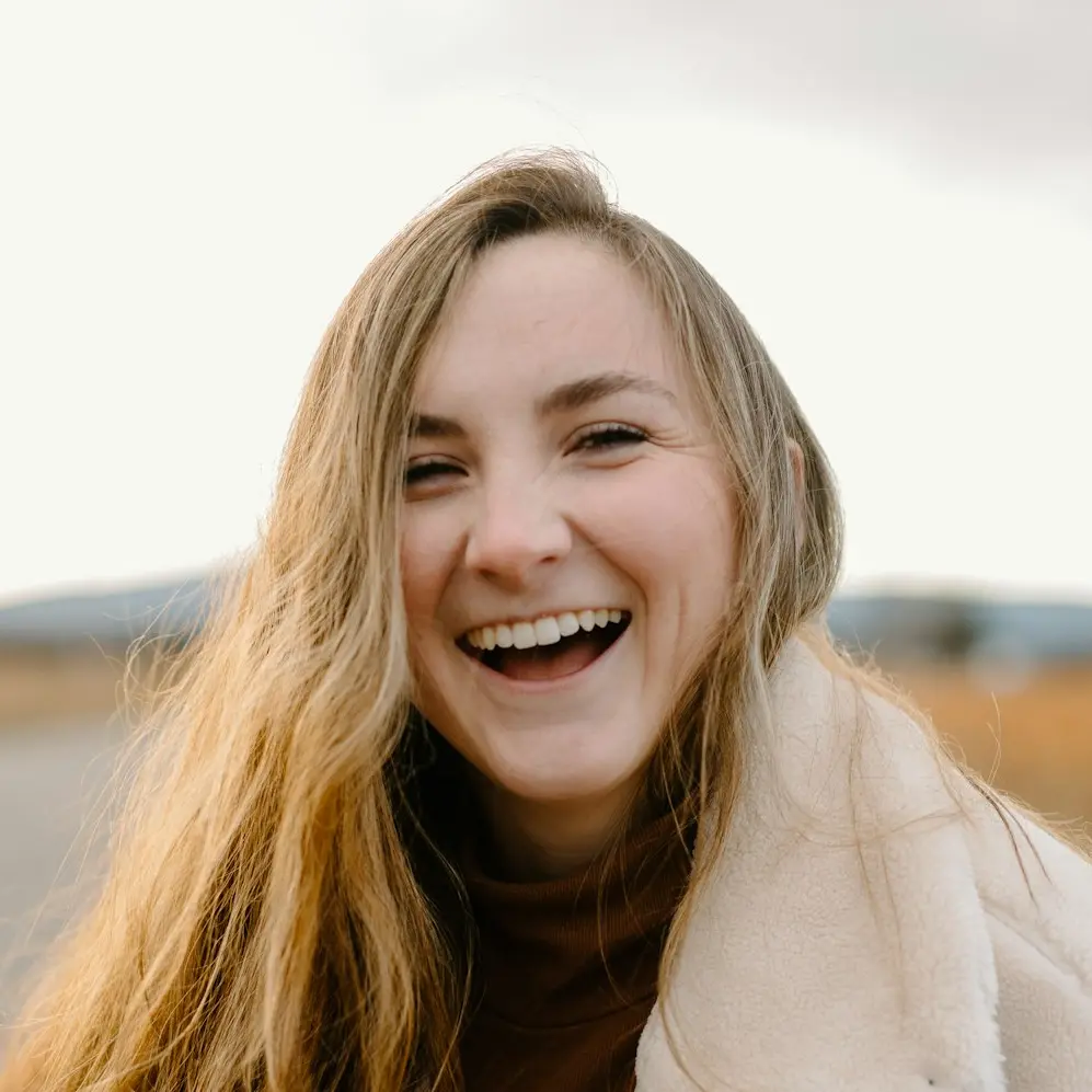 smiling woman in green jacket